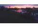 Stunning sunset over the canal with boats docked on the water at 123 Poinsettia Ne Cir, Port Charlotte, FL 33952