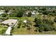 Aerial view of the home with outbuilding, situated on a spacious lot surrounded by trees and nature at 1240 Alpinia Rd, North Port, FL 34288