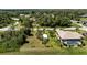 Overhead view displays the home's position relative to the outbuilding, surrounding palm trees, and lawns at 1240 Alpinia Rd, North Port, FL 34288