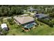 Expansive backyard with screened-in pool, complemented by lush greenery and residential neighborhood views at 1240 Alpinia Rd, North Port, FL 34288