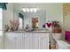 Bathroom featuring double vanity, shower, and ample counter space at 1240 Alpinia Rd, North Port, FL 34288