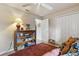 Inviting bedroom with bookshelf, closet, ceiling fan, and comfortable seating at 1240 Alpinia Rd, North Port, FL 34288