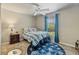 Comfortable bedroom with ceiling fan, window view, and flip flop themed decorations at 1240 Alpinia Rd, North Port, FL 34288
