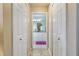 Hallway view of the vanity featuring double sinks and white cabinets at 1240 Alpinia Rd, North Port, FL 34288