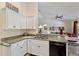Well-lit kitchen featuring granite countertops and stainless steel appliances at 1240 Alpinia Rd, North Port, FL 34288