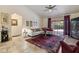 Bright living room with a vaulted ceiling, slider to the lanai, a comfortable sectional sofa and decorative furnishings at 1240 Alpinia Rd, North Port, FL 34288
