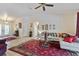 Open-concept living area with tile flooring, highlighted by a plush rug, comfortable seating, and natural light at 1240 Alpinia Rd, North Port, FL 34288