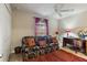 Comfortable home office with a floral couch, desk, window, and ceiling fan at 1240 Alpinia Rd, North Port, FL 34288