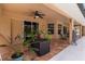 Spacious covered patio with tile flooring, plants, and outdoor seating area at 1240 Alpinia Rd, North Port, FL 34288