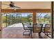 Covered patio with tile flooring and outdoor dining set overlooking the pool at 1240 Alpinia Rd, North Port, FL 34288