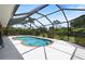 Enjoy the screened-in pool with a sun deck surrounded by a private, beautifully landscaped backyard at 1240 Alpinia Rd, North Port, FL 34288