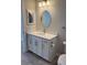 Bathroom featuring an oval mirror, vanity, recessed lights, and toilet paper holder at 1263 Cicely Ct, North Port, FL 34289