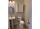 Bathroom boasts a toilet, pedestal sink, vanity, and recessed lights at 1263 Cicely Ct, North Port, FL 34289