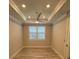 Bright bedroom features tray ceiling, ceiling fan and window with plantation shutters at 1263 Cicely Ct, North Port, FL 34289