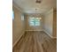 Dining room with wood floors, neutral paint, and modern chandelier at 1263 Cicely Ct, North Port, FL 34289