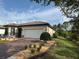 Well-maintained single-story home with a two-car garage and a neatly landscaped yard at 1263 Cicely Ct, North Port, FL 34289
