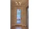 Bright foyer with stylish front door and decorative light fixture at 1263 Cicely Ct, North Port, FL 34289