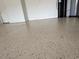 View of the neutral, epoxy-coated garage floor. Storage unit is in the background at 1263 Cicely Ct, North Port, FL 34289