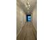 Inviting hallway with wood-look tile and modern light fixture at 1263 Cicely Ct, North Port, FL 34289
