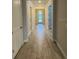 Long hallway with neutral paint, wood floors, and recessed lighting at 1263 Cicely Ct, North Port, FL 34289