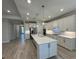 Spacious kitchen featuring an island, stainless steel appliances, and pendant lighting at 1263 Cicely Ct, North Port, FL 34289