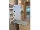 Convenient laundry room with built-in ironing board and ample counter space at 1263 Cicely Ct, North Port, FL 34289