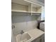 Convenient laundry room featuring built-in shelving, countertop space and utility sink at 1263 Cicely Ct, North Port, FL 34289