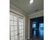 Living room entryway featuring French doors and wood look flooring at 1263 Cicely Ct, North Port, FL 34289