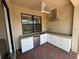 Outdoor kitchen with stainless steel appliances, granite counters and a ceiling fan at 1263 Cicely Ct, North Port, FL 34289