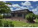 Screened-in lanai with ceiling and view of manicured lawn and foliage at 1263 Cicely Ct, North Port, FL 34289
