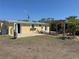 Exterior view of the home with a backyard patio at 1270 Manor Rd, Englewood, FL 34223
