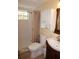 Bathroom includes a shower, toilet, vanity, and cabinet for storage at 1270 Manor Rd, Englewood, FL 34223