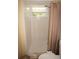 Clean bathroom with a shower and window providing natural light at 1270 Manor Rd, Englewood, FL 34223