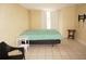 Bedroom featuring neutral tones, tile flooring, and a window at 1270 Manor Rd, Englewood, FL 34223