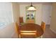 Bright dining area features wood table, seating for four, decorative hutch, and a window at 1270 Manor Rd, Englewood, FL 34223