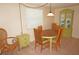 Charming dining area with a wooden table, four chairs, a decorative cabinet, and a window at 1270 Manor Rd, Englewood, FL 34223