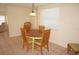 Cozy dining area with wooden table, chairs, neutral walls, and a bright window at 1270 Manor Rd, Englewood, FL 34223