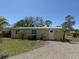 Inviting single-story home with a gravel drive and well-maintained landscaping at 1270 Manor Rd, Englewood, FL 34223