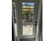 View of the outdoor patio through a glass door at 1270 Manor Rd, Englewood, FL 34223