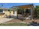 A backyard with a spacious pergola-covered patio, dining set, and lounge chairs at 1270 Manor Rd, Englewood, FL 34223