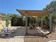 Outdoor patio featuring a wooden pergola with a dining table and lounge chairs at 1270 Manor Rd, Englewood, FL 34223