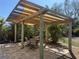 An outdoor pergola-covered patio provides an ideal spot for dining or relaxing at 1270 Manor Rd, Englewood, FL 34223