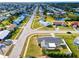 Aerial view of a long street of single Gathering homes in a well manicured neighborhood at 13575 Clara Ln, Port Charlotte, FL 33981