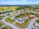 Beautiful aerial view of a single Gathering home neighborhood near the water and green spaces at 13575 Clara Ln, Port Charlotte, FL 33981