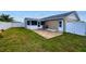 Spacious backyard featuring a wooden deck, white vinyl fence, and a screened-in patio at 13575 Clara Ln, Port Charlotte, FL 33981