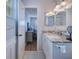 Bathroom features granite countertop, modern lighting, and an opening into main bedroom at 13575 Clara Ln, Port Charlotte, FL 33981