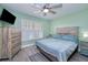 Comfortable bedroom showcasing hardwood floors, shuttered windows, and rustic furniture at 13575 Clara Ln, Port Charlotte, FL 33981