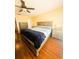 Cozy bedroom features neutral tones, hardwood floors, ceiling fan, and natural light at 13575 Clara Ln, Port Charlotte, FL 33981