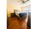 Comfortable bedroom with hardwood floors, natural light, ceiling fan, and ample storage at 13575 Clara Ln, Port Charlotte, FL 33981