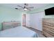 Cozy bedroom featuring hardwood floors, shuttered windows, and an adjacent closet at 13575 Clara Ln, Port Charlotte, FL 33981